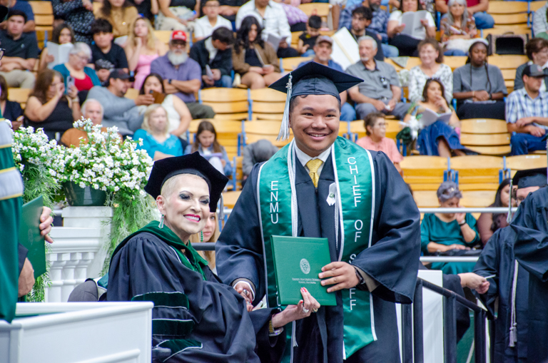 Board of Regents President Ruiz presenting a degree to a student at the past commencement ceremony.