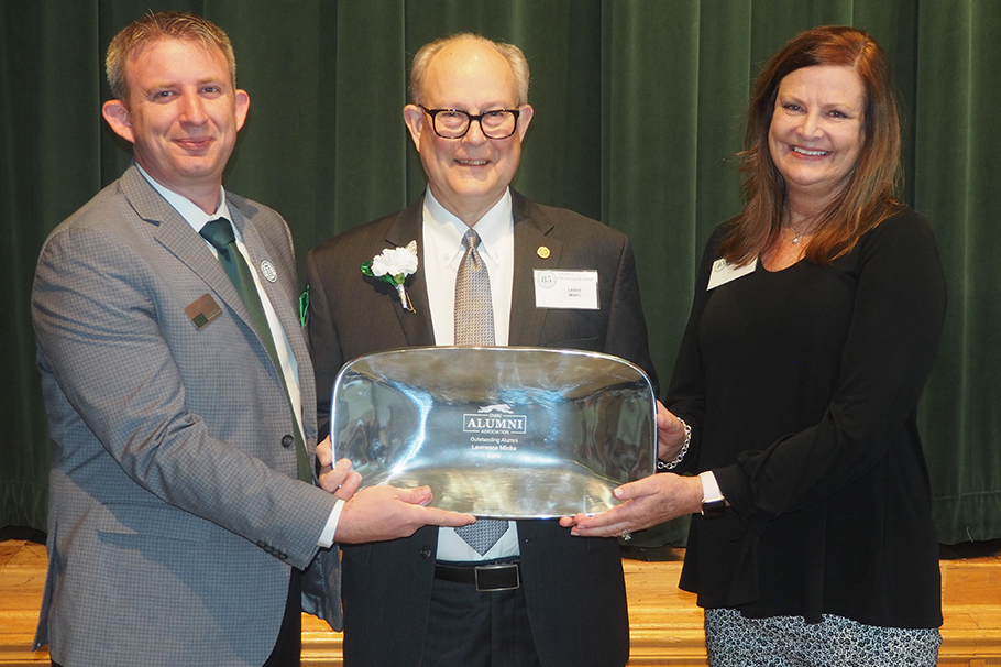 Dr. Lawrence "Larry" C. Minks (center) receiving the ENMU Outstanding Alumni award in 2019.