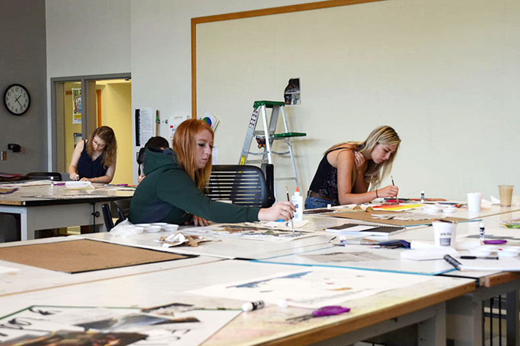 ENMU art students painting in a classroom